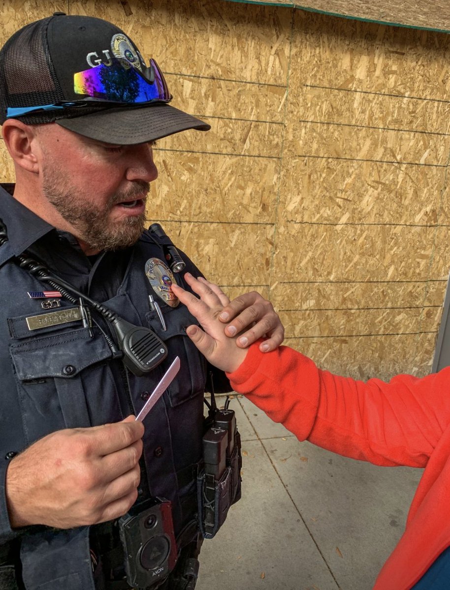 GrandJunctionPD's tweet image. Here is #GJPD Officer Eaton with Isabelle. In a world of technology and hashtags, this picture, taken at the White Cane Safety &amp;amp; Awareness Day, speaks volumes to us. A lovely moment and a great reminder of the power of human connection. #servingGJ #WhiteCaneDay #CaringCommunity