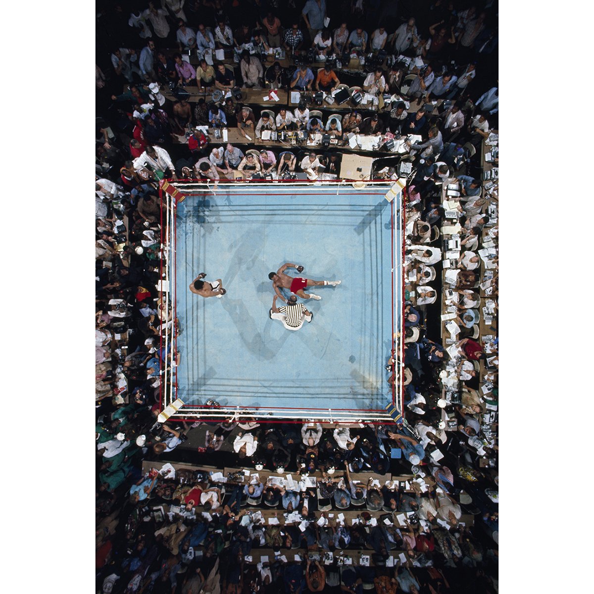 49 years ago today. Aerial view, shot from the rafters of Stade du 20 Mai Stadium in Kinshasa, Zaire, of Muhammad Ali pacing around George Foreman after an 8th round KO in the WBC/ WBA World Heavyweight Title, better known as the “Rumble in the Jungle.” #NeilLeifer #MuhammadAli