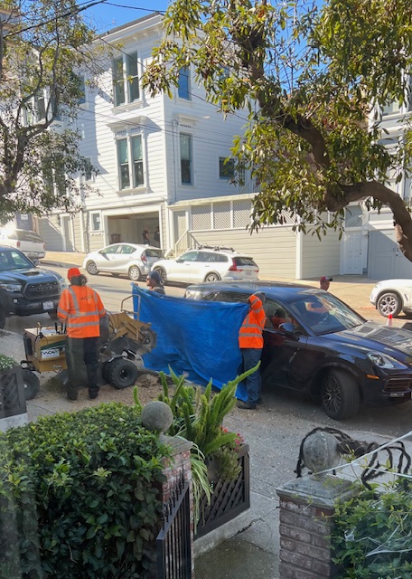 Duke_Chung's tweet image. SF Arborists from @sfpublicworks holding up a tarp to protect a car while team is removing a tree stump.  #LoveOurCity #SanFrancisco