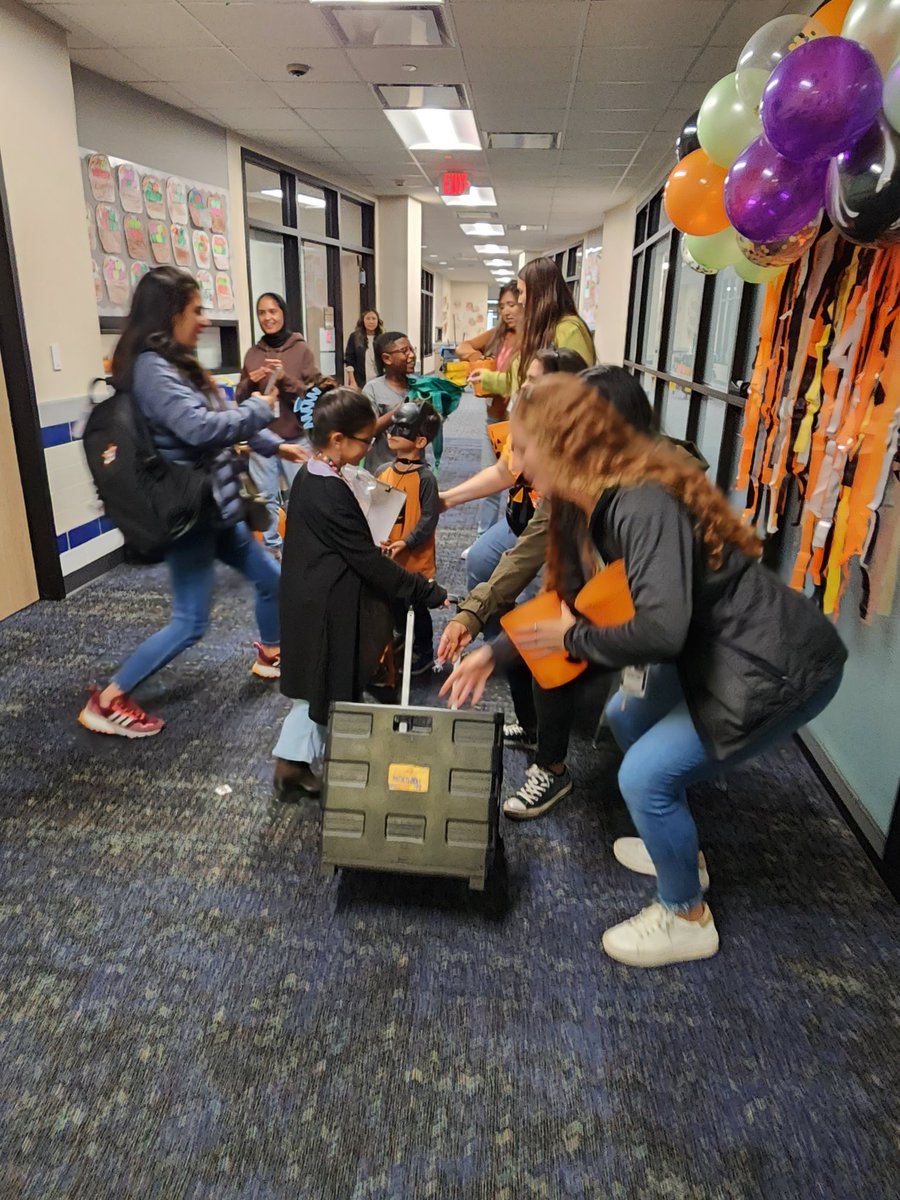 Staff trick or treat at PMCE was a huge success. Kids had a great time.  Can you guess Andrea's costume?