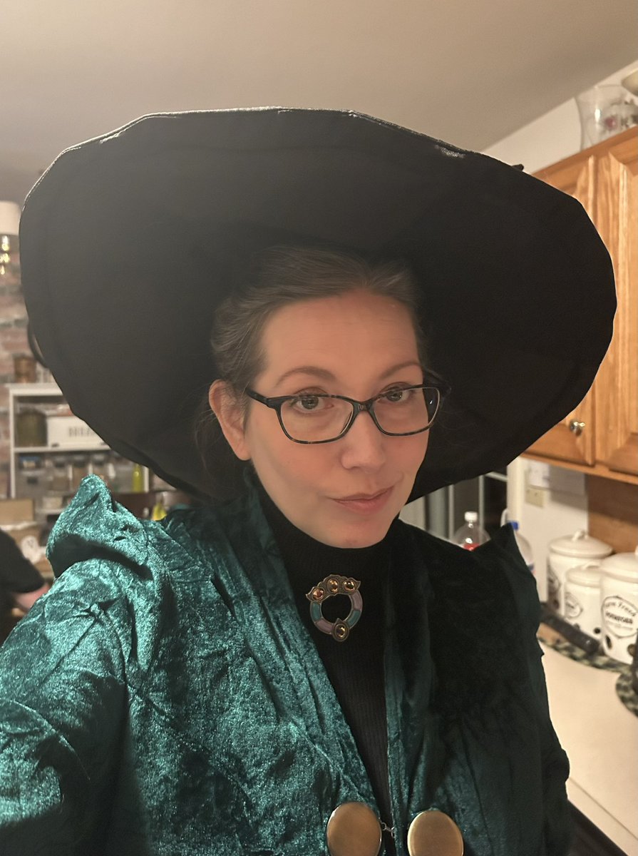 LynnSeats's tweet photo. Got to dress up for Halloween at work, decided to be Minerva McGonagall. Also brought along the Harry Potter crafts I made, including the sorting hat/spell book/mandrake #HarryPotter #Hogwarts https://t.co/YZMa8g0mdg