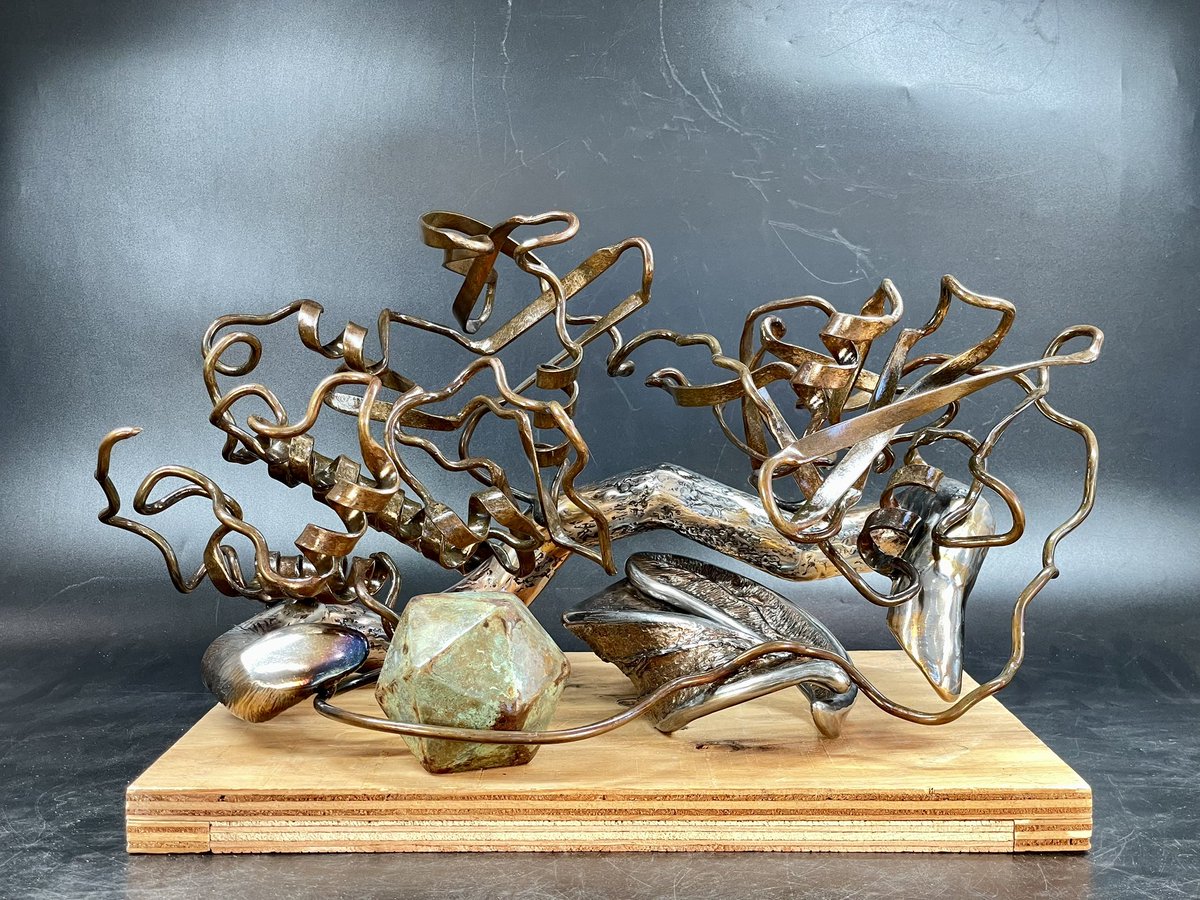 Here’s the nearly finished sculpture of the Src protein kinase. All the metal work is done, but it sits on a temp plywood base. Thinking about using a medium colored wood. Maybe lacewood? (I’m not a woodworker, ideas welcome!) The sculpture is bronze and steel.