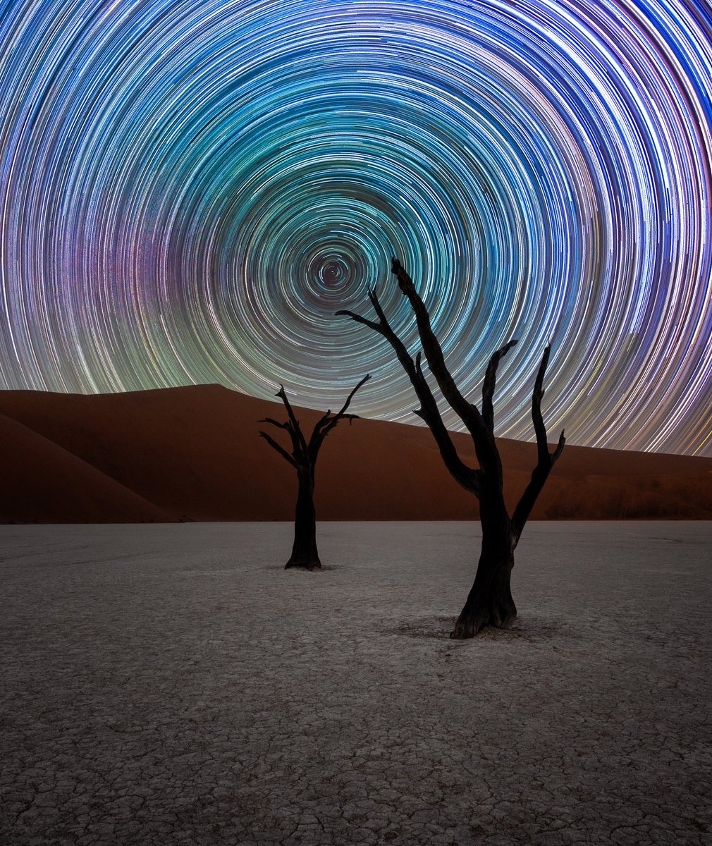 7 hours of earth rotating on its southern axis compared to stationary stars shown here as star trails. The very centre is directly south where no rotation is there due to it being on the polar axis. Trails shot at night in the campsite, foreground is Deadvlei in the early morning