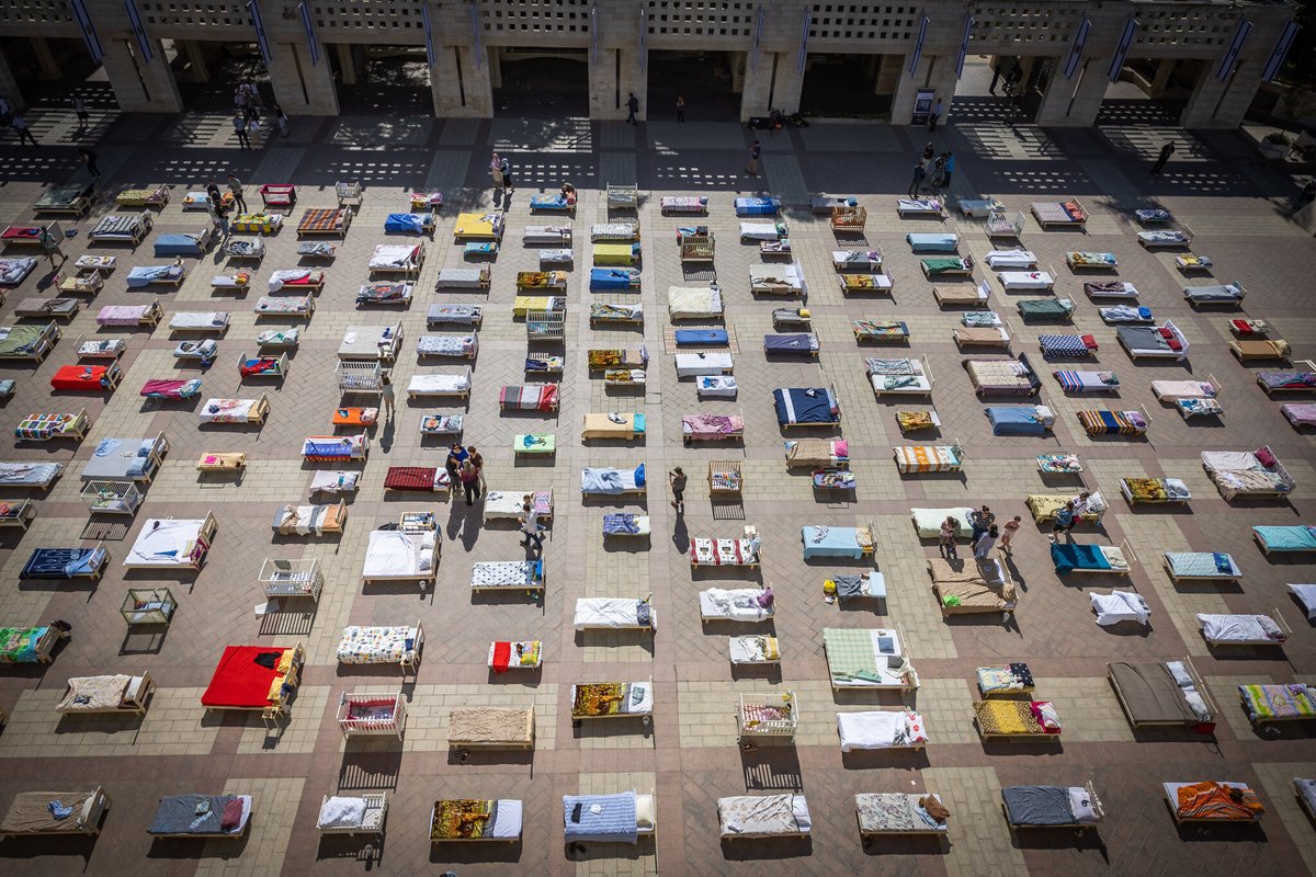 ianbremmer's tweet photo. 250 empty beds laid outside city hall in jerusalem. https://t.co/7SaUwJERiE