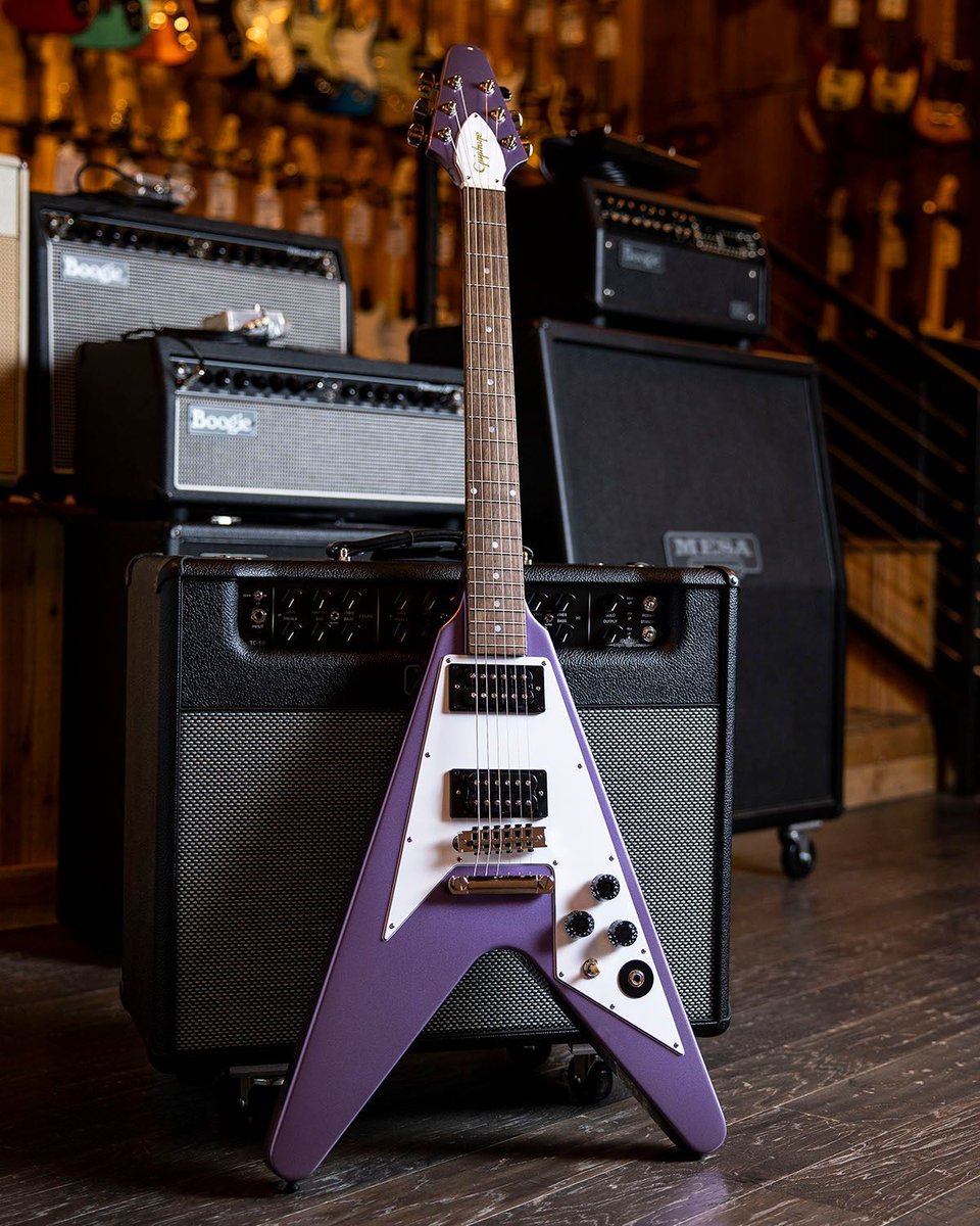 guitarcenter's tweet photo. Ride the lightning. The new @Epiphone @KirkHammett Flying V's @gibsonguitar USA Calibrated T-Type humbuckers, Rounded "C" neck, and a Purple Metallic finish deliver the aggressive tones and bold looks the @Metallica guitarist is known for. Check it out: https://t.co/dZMmGhGFji https://t.co/XoPvAQXFZG