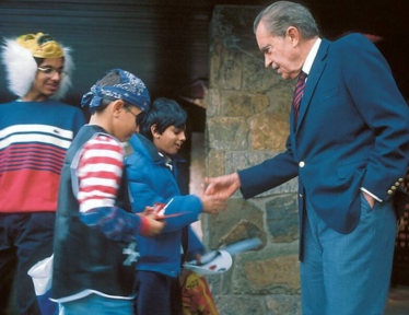 President Nixon greets children at his home moments ago. - RZ