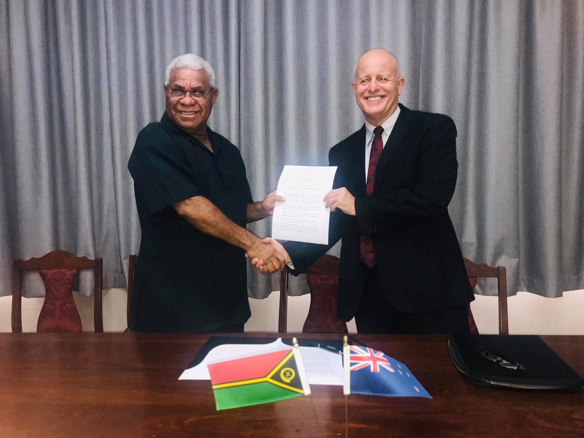Prime Minister of Vanuatu Bob Loughman Weibur and New Zealand High Commissioner Jonathan Schwass with the signed Arrangement for one-way quarantine-free travel from Vanuatu to New Zealand