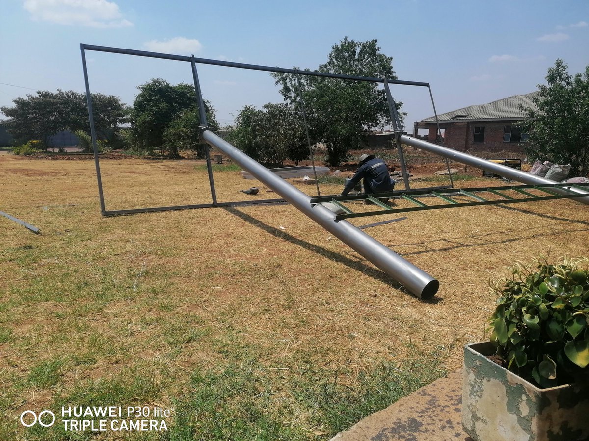 Eng_Madziva's tweet photo. Energy Update: Friday Installation. Roof had inadequate space for us to do a roof mount pv installation so we had to fabricate a frame specifically designed to accomodate the 535W panels to harvest the energy from the sun. An offgrid 5kva system. #SolarShackInstallation https://t.co/0Gb9faCNUG
