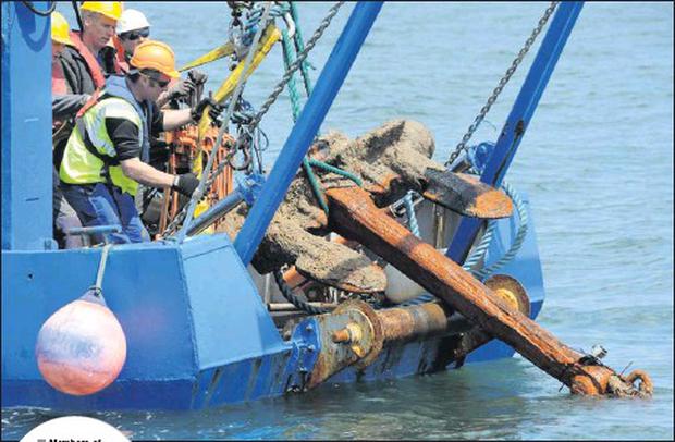 hashtagcobh2020's tweet photo. Members of archaeological expedition team recover one of the anchors from the 1916 gun-running ship The Aud from the water off Cobh on Tuesday morning. https://t.co/3RqROTV6Qb