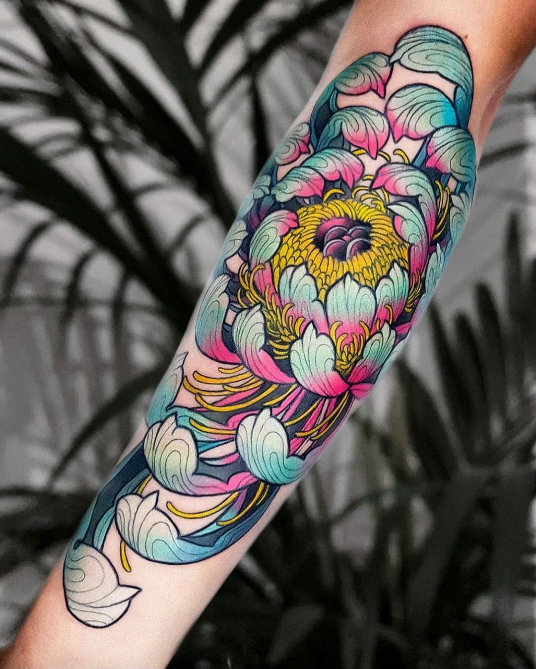 Matching chrysanthemum tattoos.
