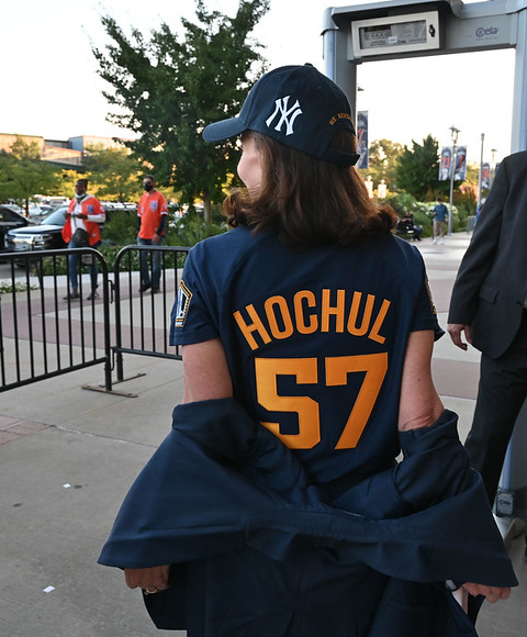 Governor Hochul wear jersey with number 57 on back and baseball cap showing Yankees logo