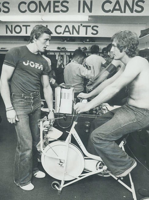 mikecommito's tweet photo. Goaltender Wayne Thomas hits the bike and chats with “The King” at the start of @MapleLeafs training camp in 1976 #Hockey365 #LeafsForever https://t.co/LjxPuc5BMJ