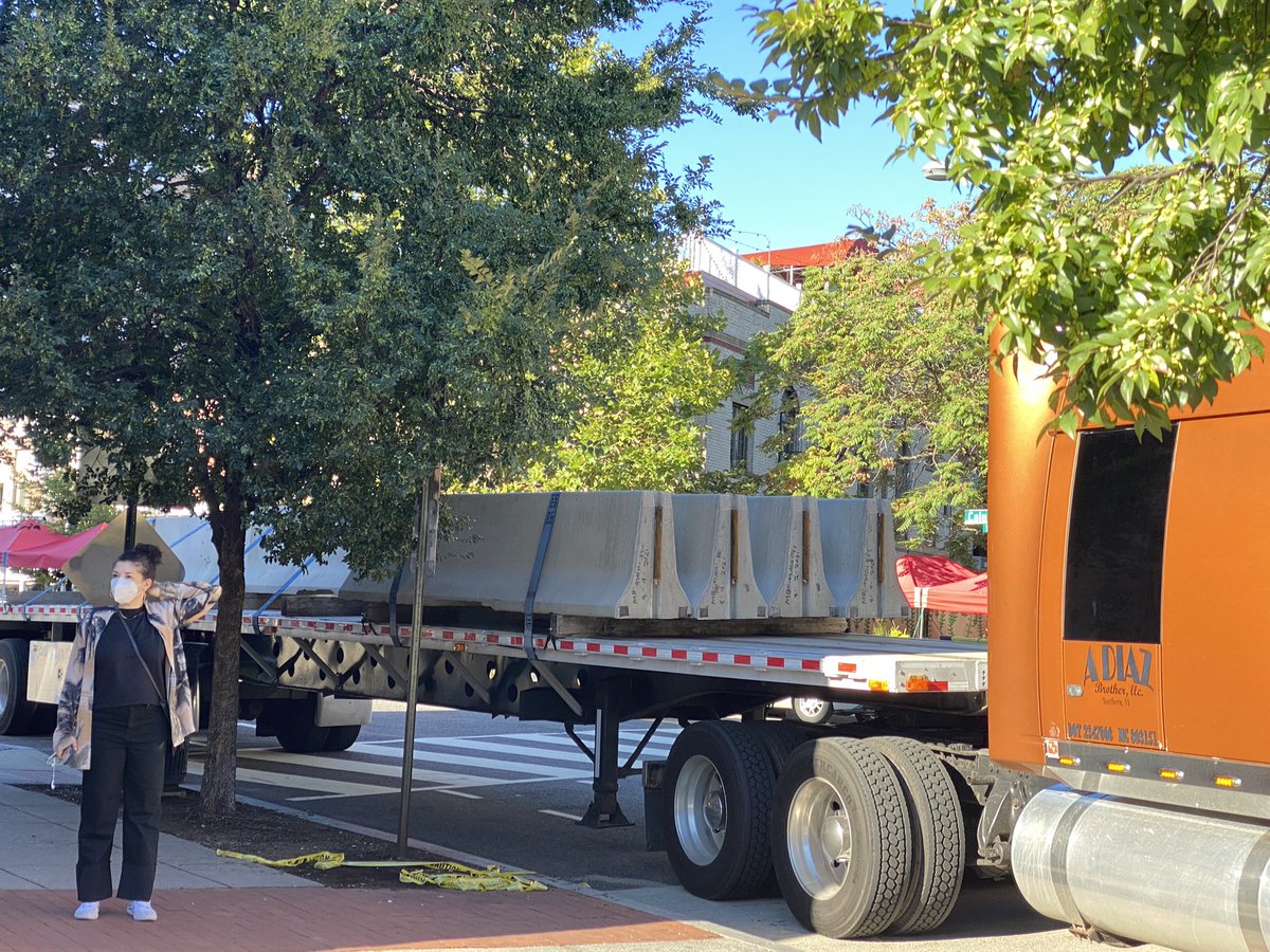 jillij's tweet photo. Adams Morgan Plaza: 3 Semi Trucks full of concrete barricades arrived at admo plaza early this morning - Truist bank vultures *again* tried to steal public land. No permits so they came at 5am. Destroyed a mutual aid tent and community art. Sick shame. Stopped by the people again https://t.co/cGPRwVlUpn