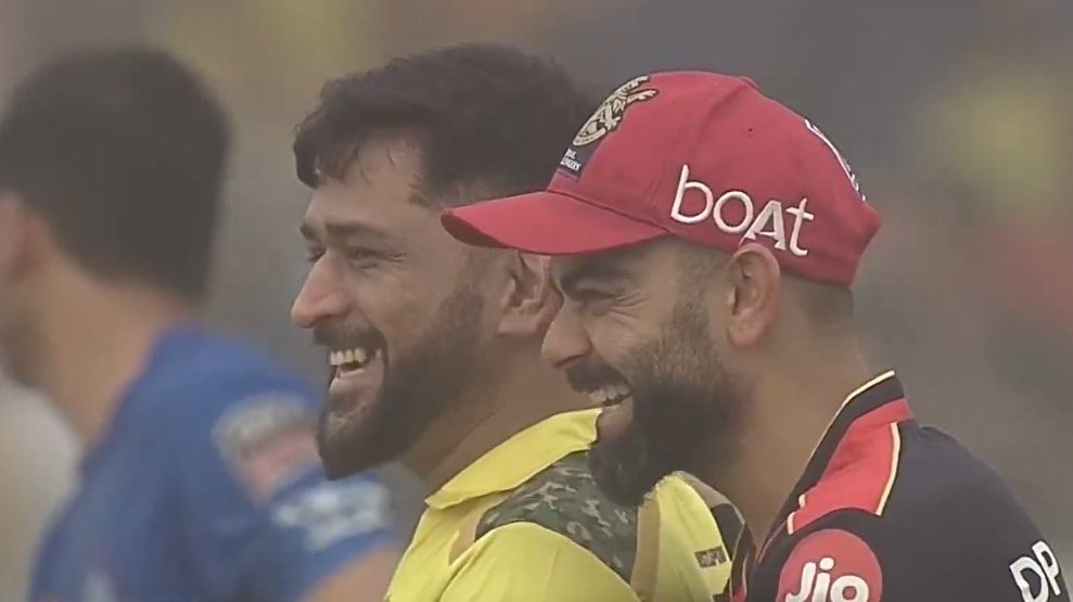 sagarcasm's tweet photo. Dhoni and Kohli watching their fan clubs fight with each other https://t.co/aLIgGZ5Vcr