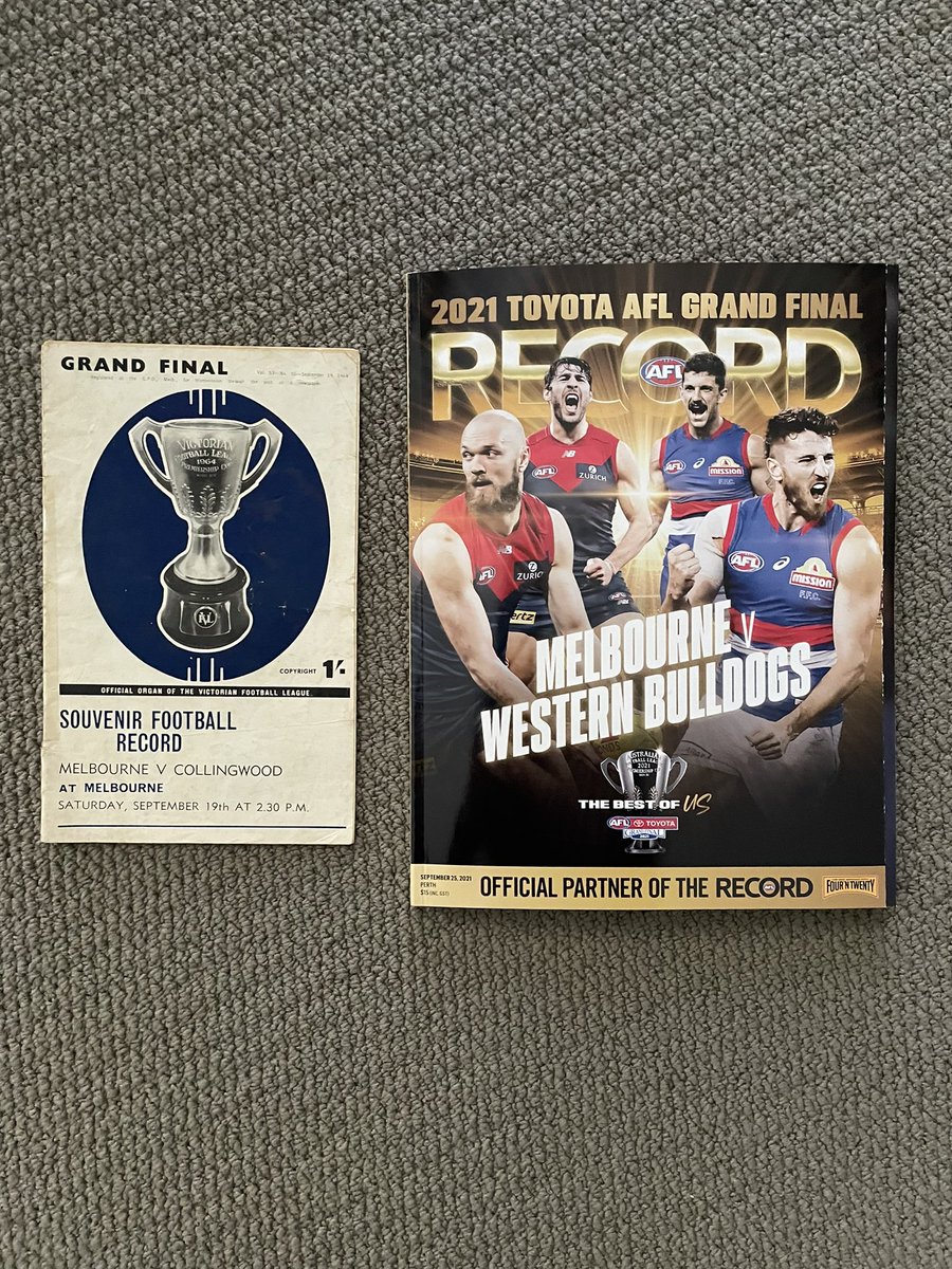 MattBurgan's tweet photo. 2019-now: The Melbourne ‘shrine’ came down in 2019, after family home sold after 46 years. The team poster is from 2020. And the 2021 GF footy record (along with ‘64) means we’re back contending. What a day! And one of my fav pics: Dad and me in 1983. Carn’ the Dees! #giveemhell https://t.co/hN0eDHuVV1