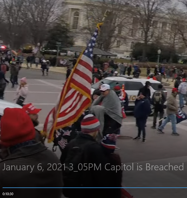 creek_twit's tweet photo. Here is #ToolTimePB leaving the capitol with the flag he looted from inside. (#FlagStealer)  10:30 in https://t.co/QvW9X4hOUV https://t.co/lgxupLauIp