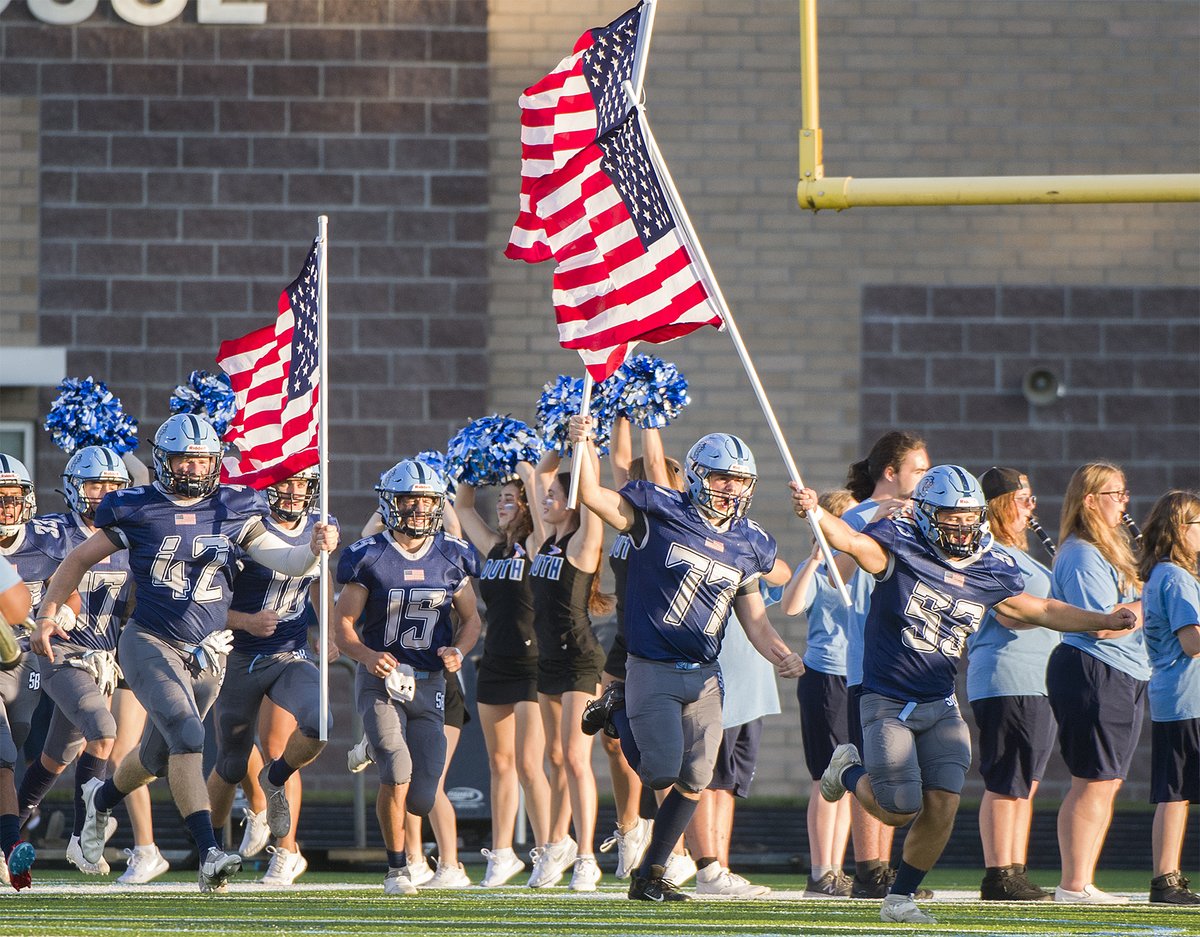 MichaelGPaul's tweet photo. South Brunswick @athletics_sbhs  seniors Shelton Bocook, John Lee and Theo Wood cary American flags onto the South field before the start of the football game against New Hanover on Military Appreciation Night. https://t.co/rB32pEYxRr