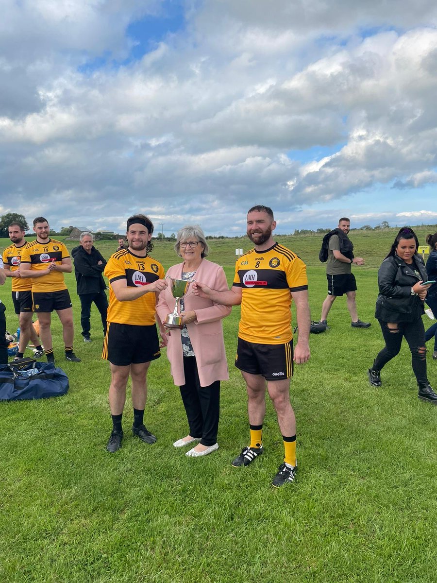 EastBelfastGAA's tweet photo. Congratulations to our hurlers on their victory against Portadown St Malachy’s for the Larry O’Neill cup. St. Malachy’s were 1 of the 1st teams we played &amp; this fixture is a highlight since. Captains Tony Ferris &amp; Rory Maguire receive the cup from Isobel O’Neill. @stmalachyshc https://t.co/Z8fObGr70M