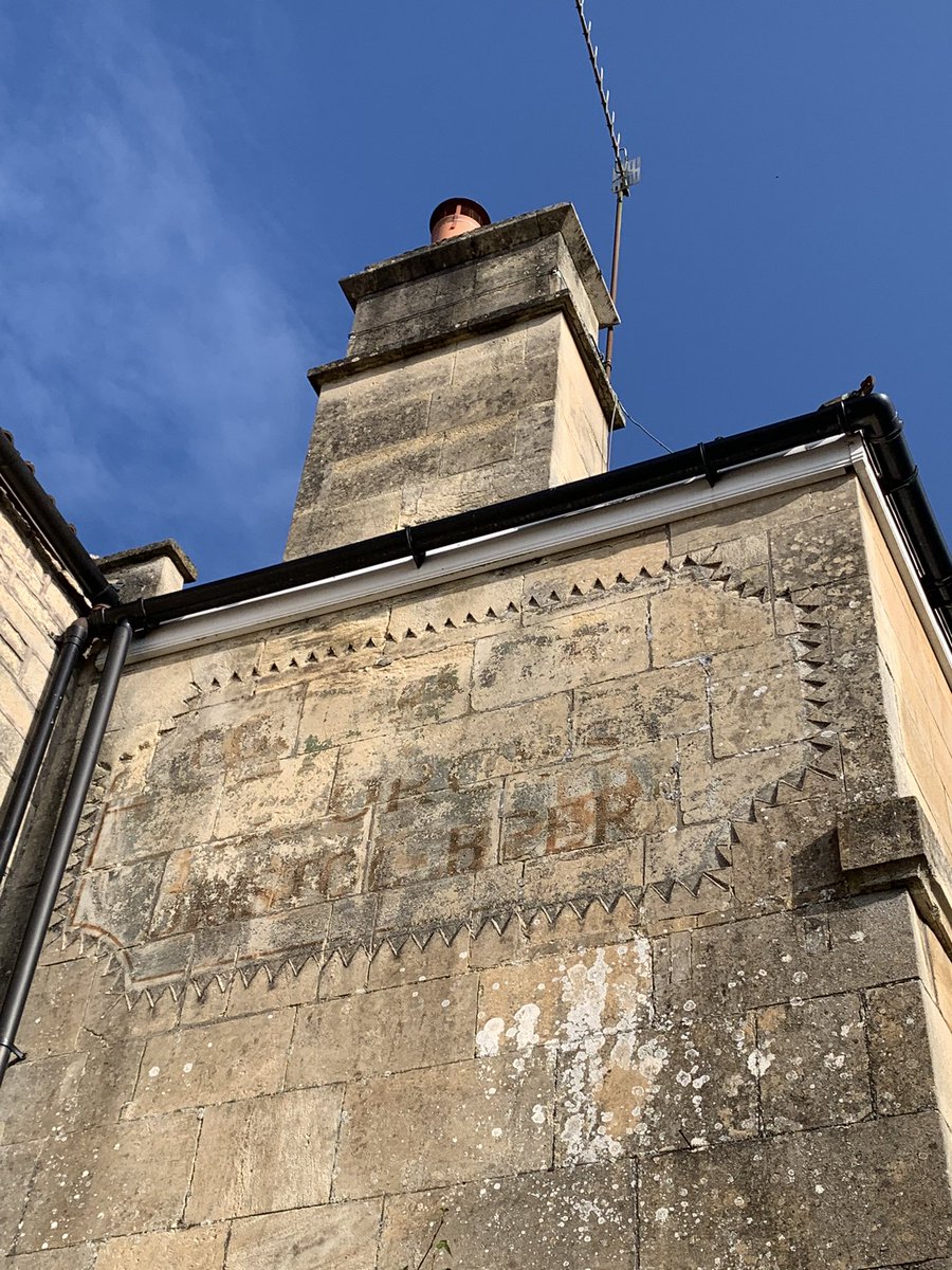 Nice stone carving to frame an old painted pub sign. Northend, Bath.