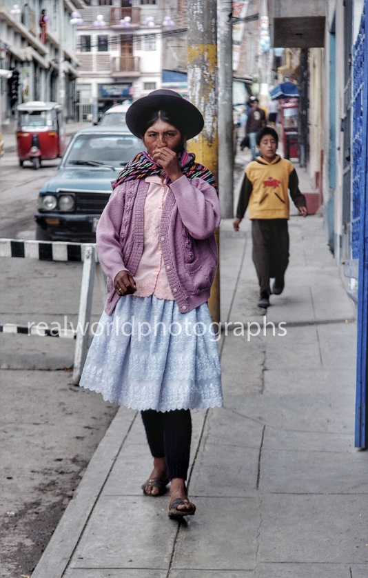 A woman walks down an Ayacucho street. Peru, South America. 2007. Gary Moore photo. Real World Photographs. #peru #photojournalism #photography #realworldphotographs #garymoorephotography #women #southamerica #ayacucho #nikon #malmo #sweden #travelphotography  