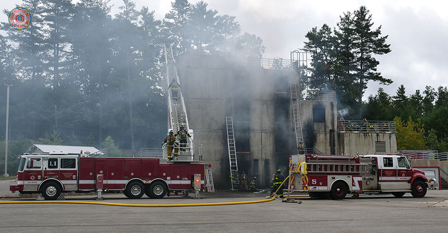 MassDFS's tweet photo. Last week, #recruits from #Class295 had a busy day at the burn building. During this evolution recruits used the aerial truck to climb to the roof, while other recruits were setting up ladders. This allowed them to fight fires in different parts of the building at the same time. https://t.co/res751VEm5