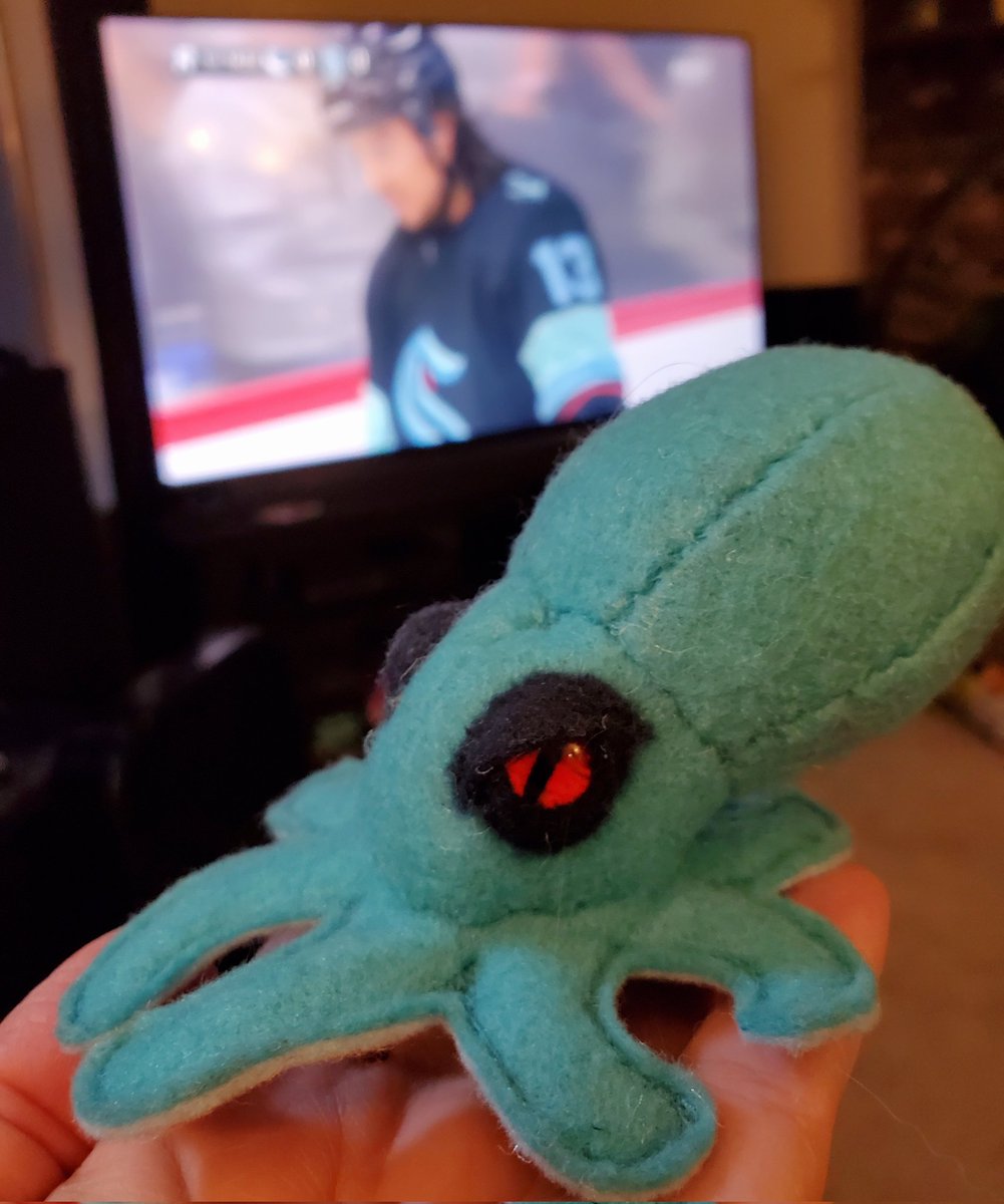 Small felt Kraken with red eyes and created in Seattle Kraken colors