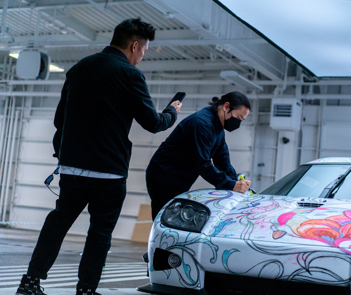 mixtus's tweet photo. Art is a magical force✨  @JamesJeanArt coloring the “2nd fastest art car coloring book”. This is the @koenigsegg CCX known as Big Brother wrapped with Jame’s art. Proceeds go to the Festival of Children Foundation. 🙏 @timcadiente for pushing boundaries. #art #artcar #jamesjean https://t.co/4jFfkMw082