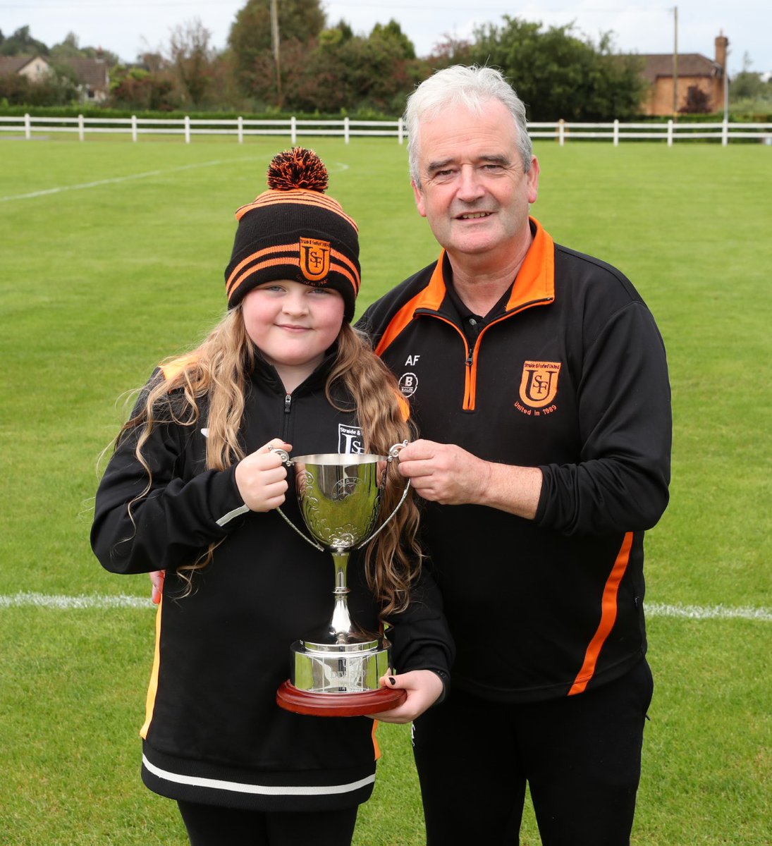 thecontel's tweet photo. Lily Keenan pictured with the TF Royal Hotel and Theatre Under 21 League Division 2 trophy, alongside @straidefoxfordu joint manager Aidan Flatley, after the club's victory over Swinford in the final at Solar 21 Park, Milebush. https://t.co/OTe5JRaBhL