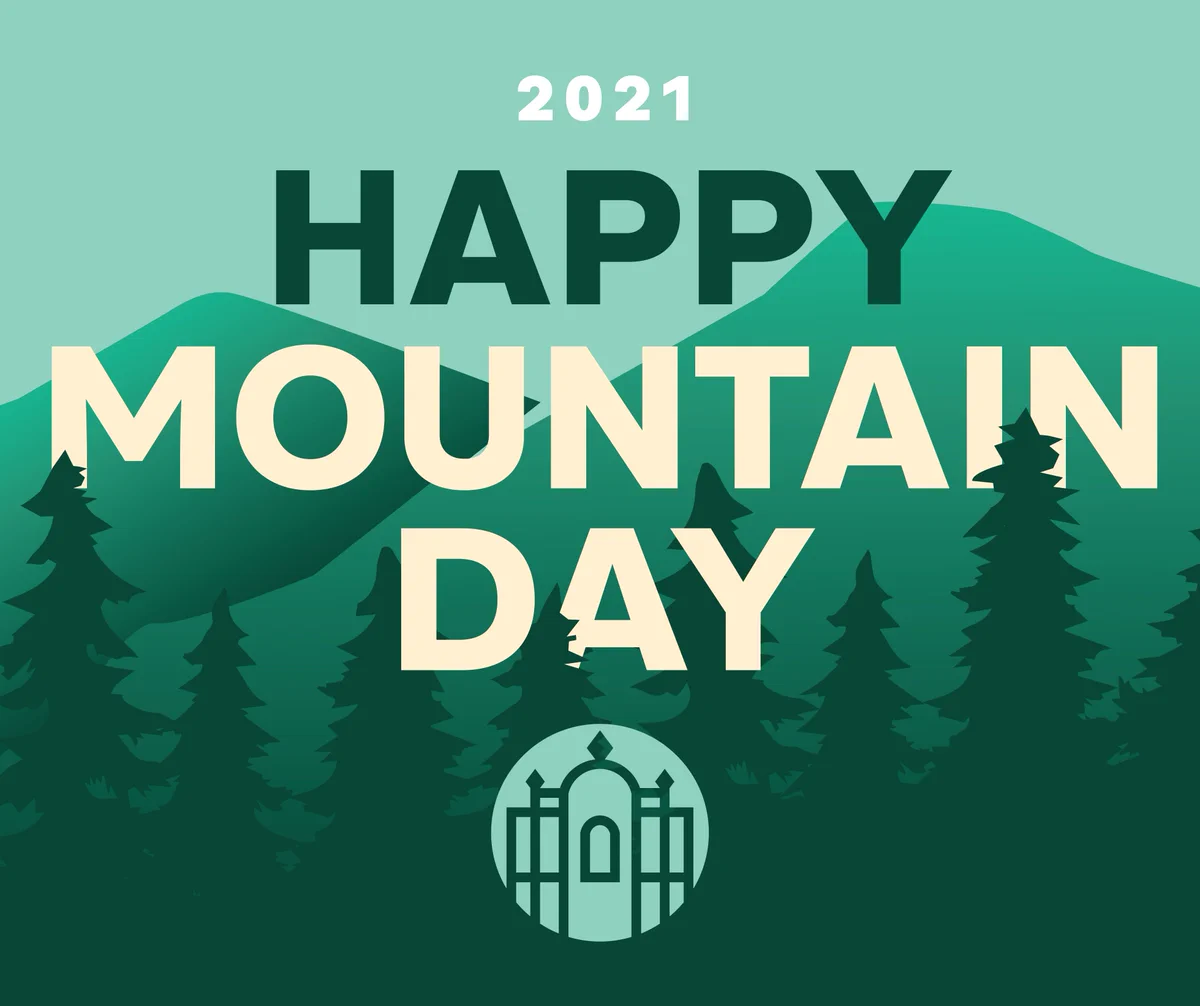 The words Happy Mountain Day in green and yellow on a background of mountain outlines and trees in shades of green.