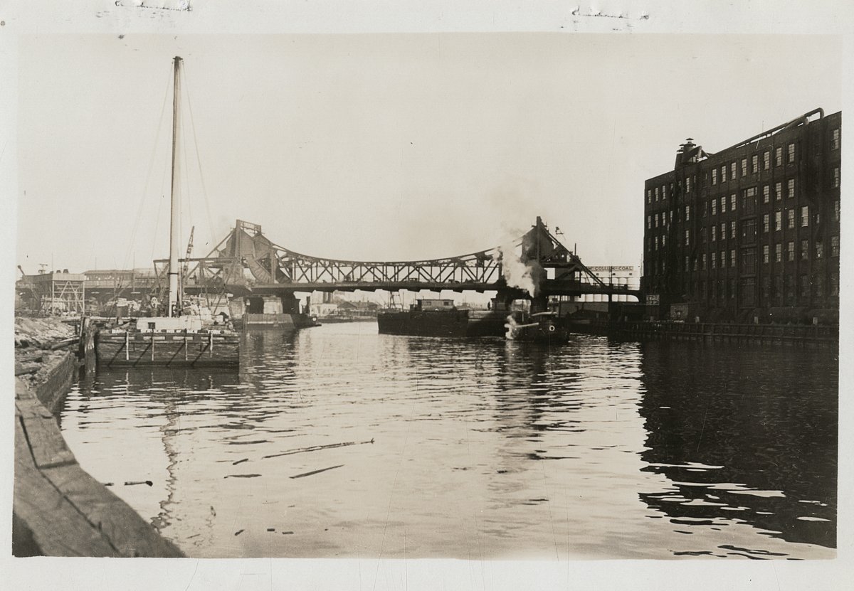 QueensMemory's tweet photo. #OnThisDay in 2010 the EPA designating Newtown Creek a Superfund site. This photo by Eugene L. Armbruster shows the Vernon Blvd Bridge crossing over Newtown Creek connecting Brooklyn & Queens in 1930 - replaced by the Pulaski Bridge in 1954. #QPLDigitalArchive #newtowncreek https://t.co/Zqhgo5ktqR