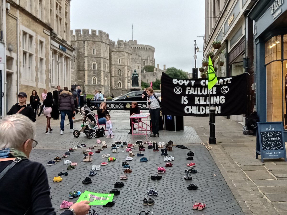 Citizens come to the crisis talks table set up by Surrey Extinction Rebellion by Windsor Castle. Banner reads "Government climate failure is killing children"