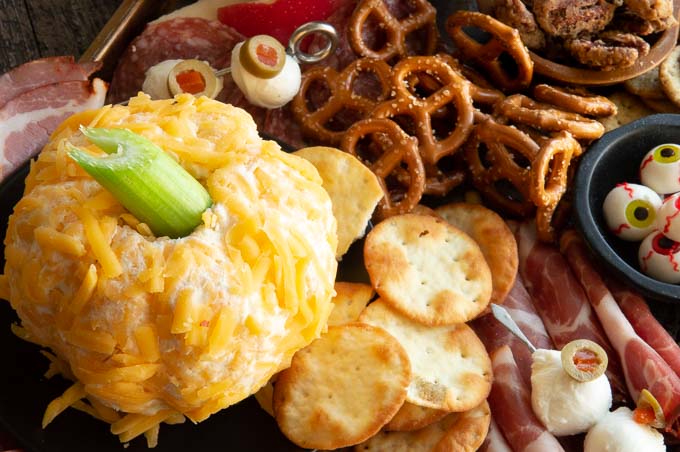 A Jackolantern/Pumpkin shaped cheese ball and mozzarella eyeballs will be the star of your Halloween-themed cheeseboard. These festive Halloween food ideas can be made in no time at all without any special things to buy! westviamidwest.com/halloween-part…