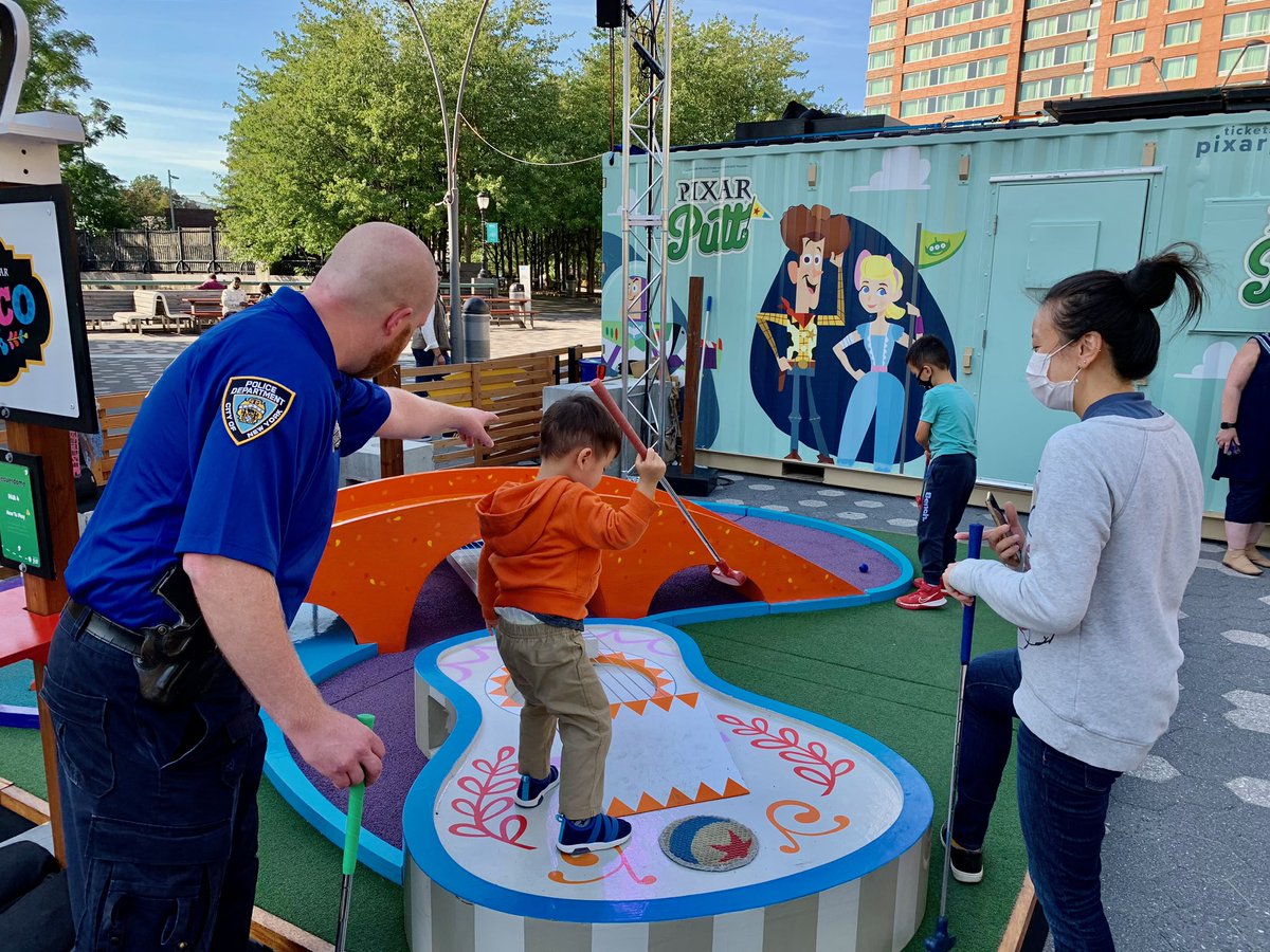 NYPDnews's tweet photo. .@NYPD1Pct teamed up with @PixarPutt today to bring cops and kids together in the name of mini-golf! New friendships were “foreee-ged” as players competed for victory. Of course, all winners here on this beautiful afternoon. https://t.co/olAvynVHps