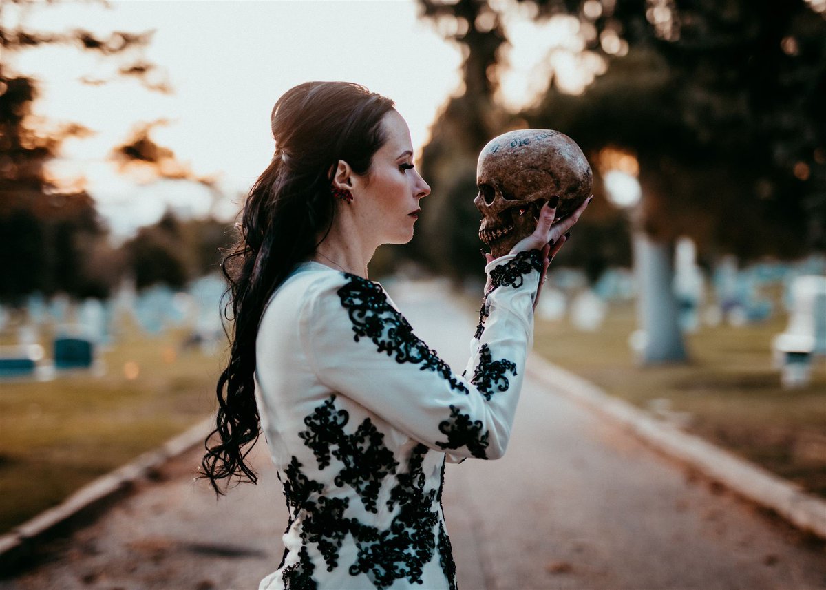 April_Slaughter's tweet photo. Just me, in a cemetery, wearing my grandmother’s gown, conversing with a friend. For absolutely no reason at all, except that it’s just something I would do. 💀🤘🏻🖤

#cemetery #skull #slaughterskulls #scarylady #aprilslaughter https://t.co/Z7pxEew8mZ