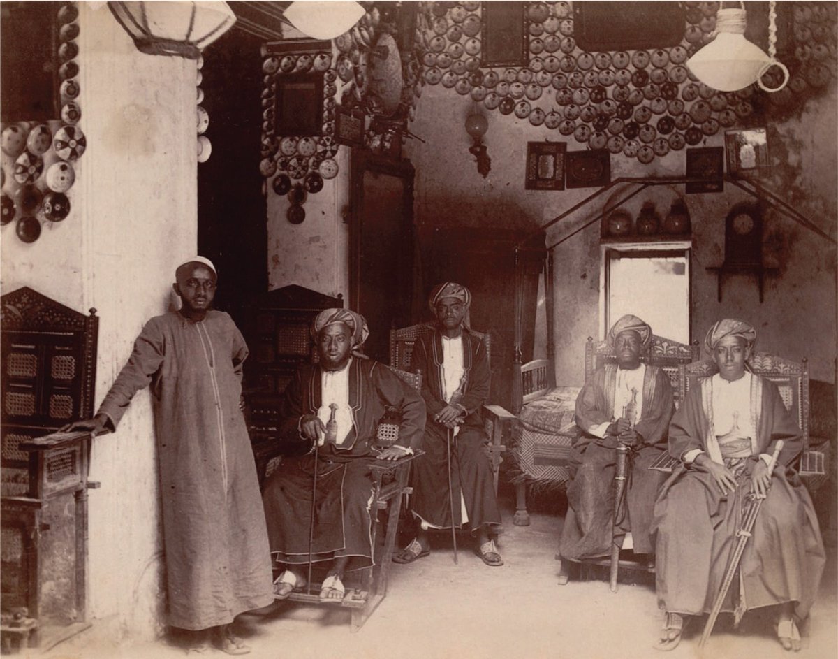 1884 Photograph of Swahili patricians sitting in state in a richly