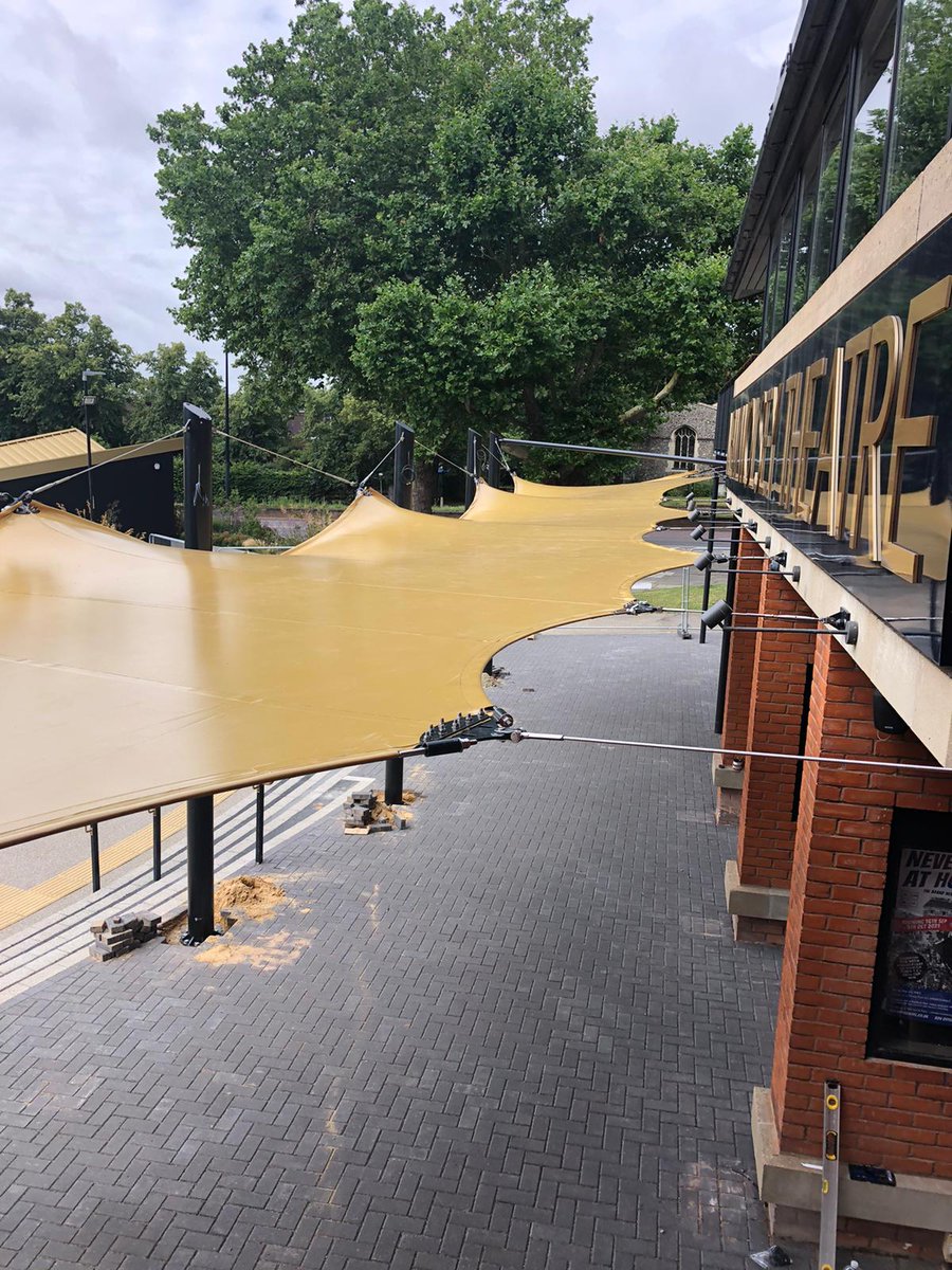 Arc_Structures's tweet photo. Our just completed gold tensile fabric canopy creates a dramatic entrance at The New Wolsey Theatre in Ipswich. We think it looks great - and they all seem pleased as punch too! #tensilearchitecture #fabriccanopy #happyclients https://t.co/QEyuDDjFWc