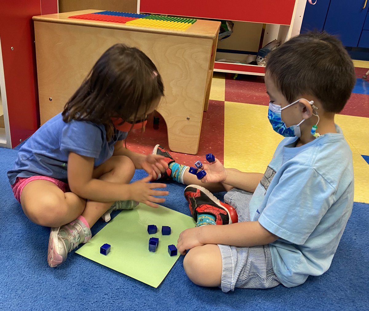This early learner partner places 4 cubes on her partner’s fingers and then wonders, if some of these cubes move to fingers on the other hand, would it still be 4? #trinitylearns <a href="/krichardsonmath/">Kathy Richardson</a>