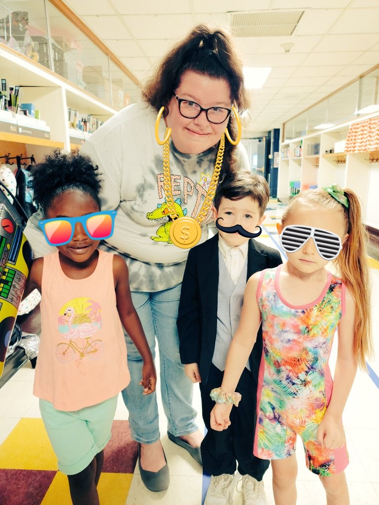 JBryan21463807's tweet photo. Decades day at school today. We dressed up! Look at that 50s suit and our 90s stuff!!! We are sparkling!! Those accessories are stickers not really on me or the kids lol https://t.co/wq3tOv40k4
