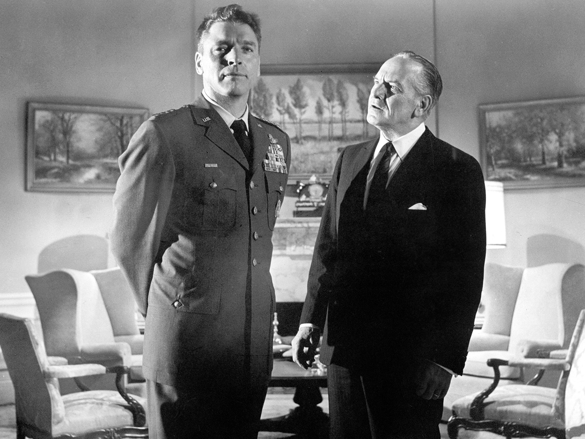 What if the Joint Chiefs of Staff decided to overthrow the president of the United States in a military coup? 

That's the intriguing premise behind John Frankenheimer's SEVEN DAYS IN MAY ('64). The film stars Fredric March as the President, and Burt Lancaster as General Scott.