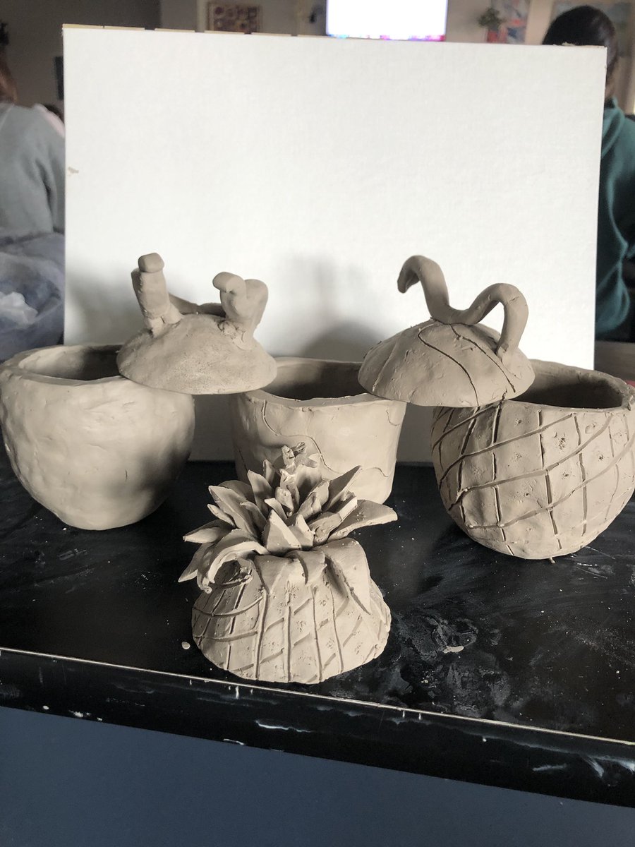 Ms_Landsbach's tweet photo. Ceramics 1 students creating lidded vessels from 2 pinch pots! Well done Katerinne, Kimberly, Lucas, and Jalissa! #ehhs #ceramics #pinchpot #doublepinchpot #pineapple #sugarskull #dinosaurs #snake Student’s signatures will be stamped on the bottom! #makersmarks https://t.co/78XkzEoXfu