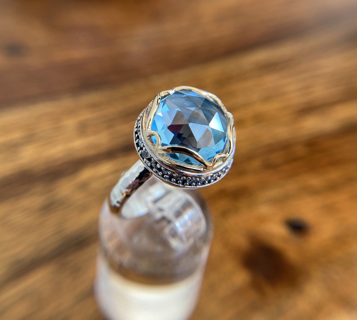 Eye Of The Beholder Ring

Atop this ‘Eye of the Beholder’ band ring adorned with intricate CZ gems etching. Handcrafted eye-catching Swiss blue topaz surrounded in a delicate 9 carat gold bezel. #bluetopazring #rings #yaronmorhaim