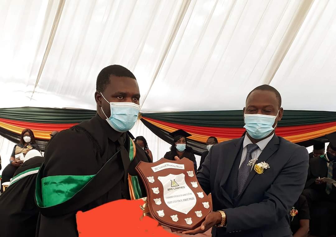 Deputy Minister of Lands, Agriculture, Fisheries, Water and Rural Development Honourable D. Karoro Presenting ZFC Limited Floating Shield to Best Student in Pest Control at Chibhero Agric College Graduation Ceremony today. 
#HelpingYouGetABetterCrop #
#TrustedBrand