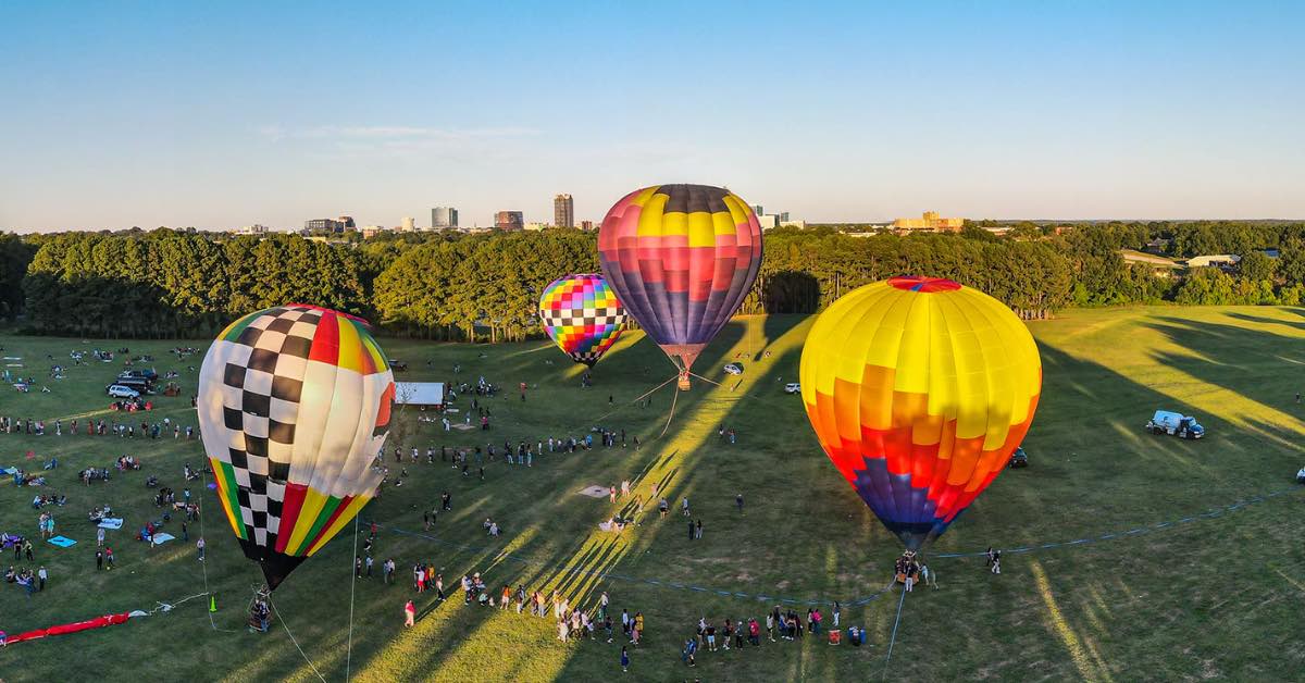 BOSdigital's tweet photo. 🎈Let's get CARRIED AWAY, reminiscing on the blue skies and hot air balloons–what a way to show off our beautiful city! Nothing can beat the Raleigh Balloon Glow Event from last weekend at Dorothea Dix Park. #RaleighBalloonGlow #BOSDigital #LifeIsDigital https://t.co/54sUKRGXIt