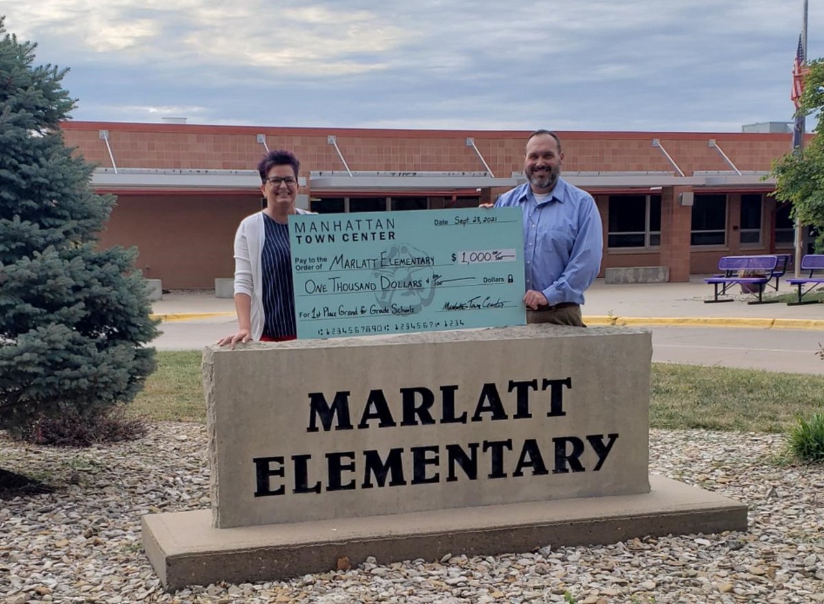 Congrats to Marlatt Elementary, a first time winner of the 17th Annual Manhattan Town Center Grand for Grade Schools contest. Pictured are Marlatt Principal Sheila Stephens  receiving the $1,000 award from MTC Marketing Manager Jeff Sutton (right).