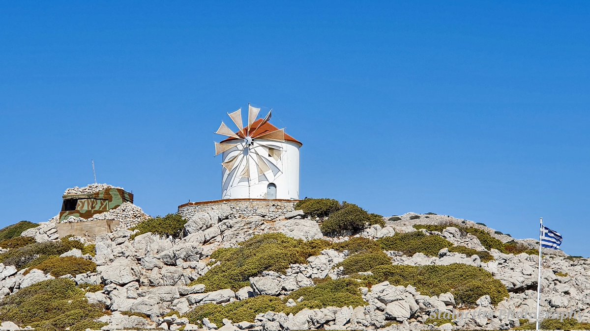 Stalactitephoto's tweet photo. Another shot from Ponormitis Monestry and the little windmill as you enter the harbour. 
#Greece #panormitis #windmill #harbour @ThePhotoHour https://t.co/DF5kq2tcF9