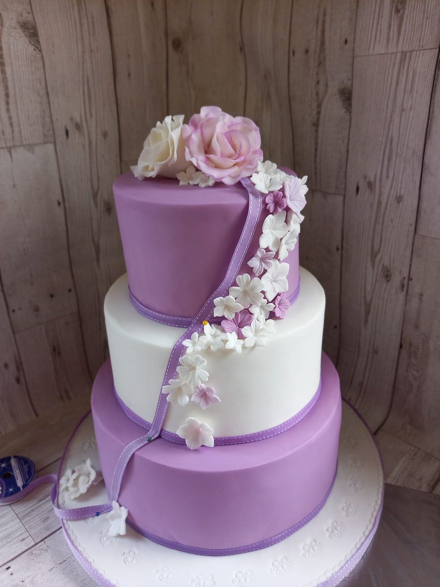 ruthscakery's tweet photo. Congratulations to Sophie and Aman it was a pleasure to make your wedding
Cake.
Raspberry and white chocolate, Lemon &amp;
Victoria sponge covered with 
Lilac &amp; white fondant 😍😍
Topped off with handmade roses and a cascade petunias in white lilac 🌸
#bespokeweddingcake https://t.co/awCP0ExYZX