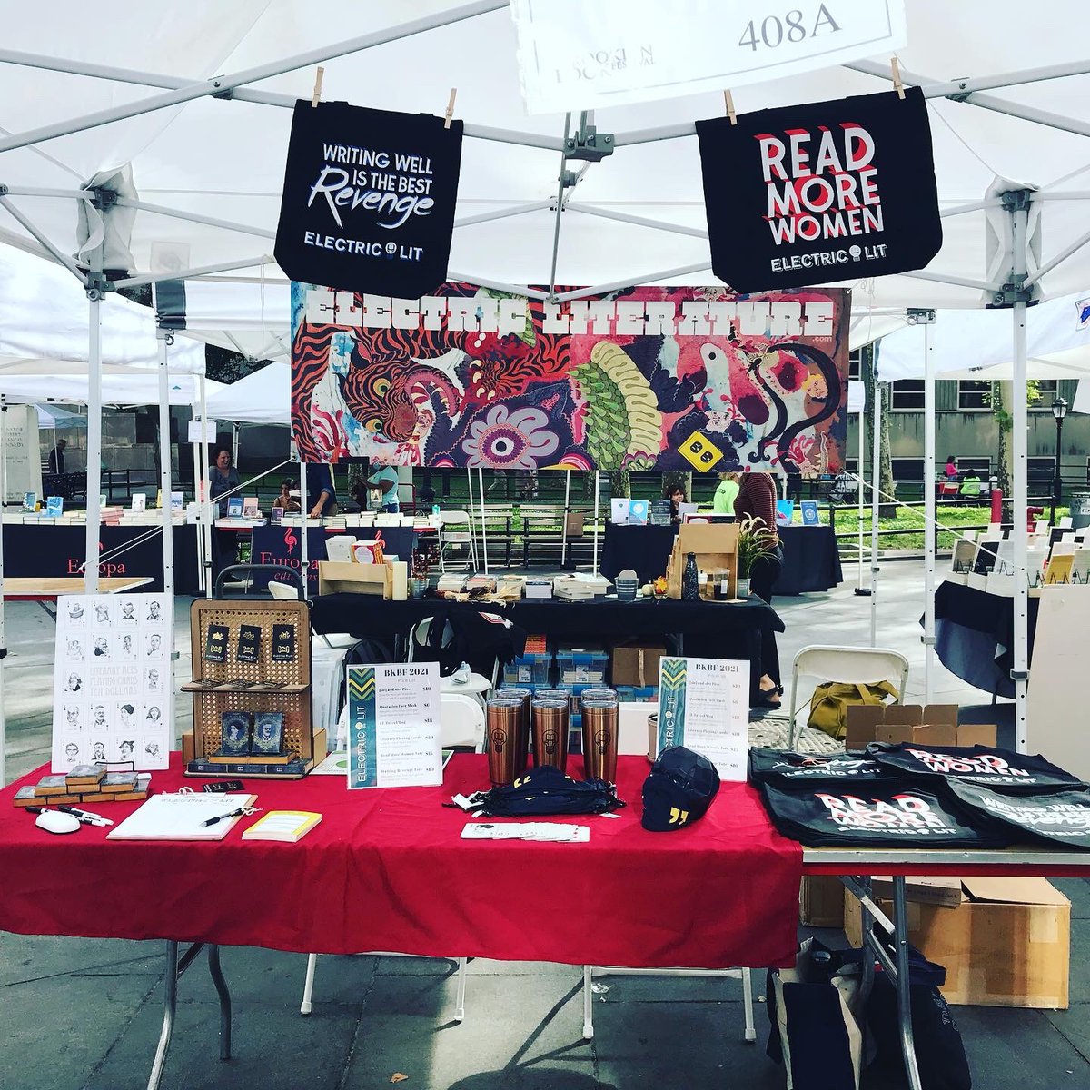 ElectricLit's tweet photo. The Electric Lit @bkbookfest booth is open for business! We have snazzy new merch, including READING INTO EVERYTHING travel mugs ($18), and Quotation face masks ($6). Stop by #408a, right at the intersection of Court and Montague! https://t.co/2zPHhLLhZq