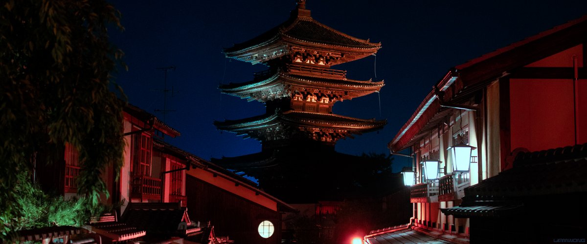 Photography by Liam Wong of Kyoto at night. The famous temple lit up in red.
