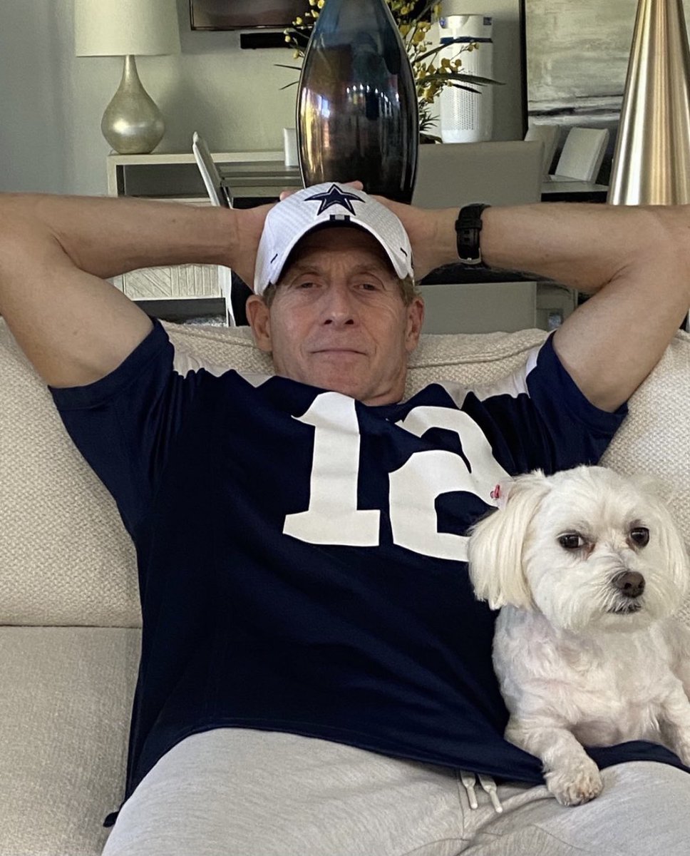 RealSkipBayless's tweet photo. Here are Hazel and I basking after we watched the Cowboys flex their potential against Carolina. I’m wearing my Staubach throwback because this team is starting to remind me of the great old days. #AmericasTeamIsBack https://t.co/147Nd5Yq9c