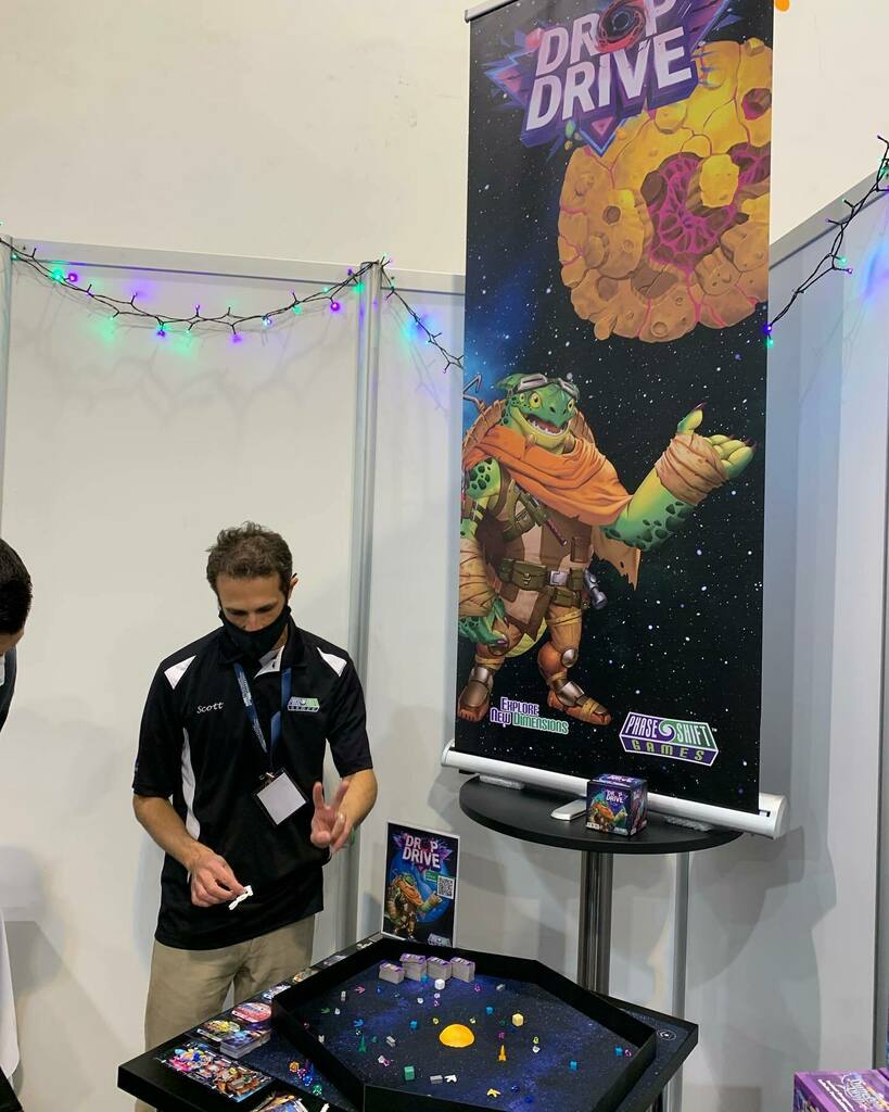 PhaseShiftGames's tweet photo. Scott showing off #dropdrive at #essen!! #boardgames #kickstarter #tabletop https://t.co/oxW0dvLAup